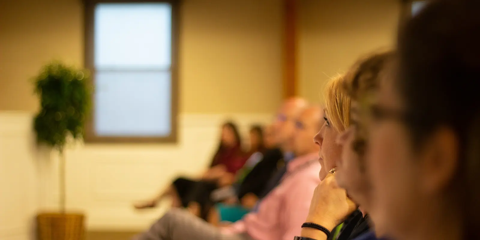 People listen during a community information session