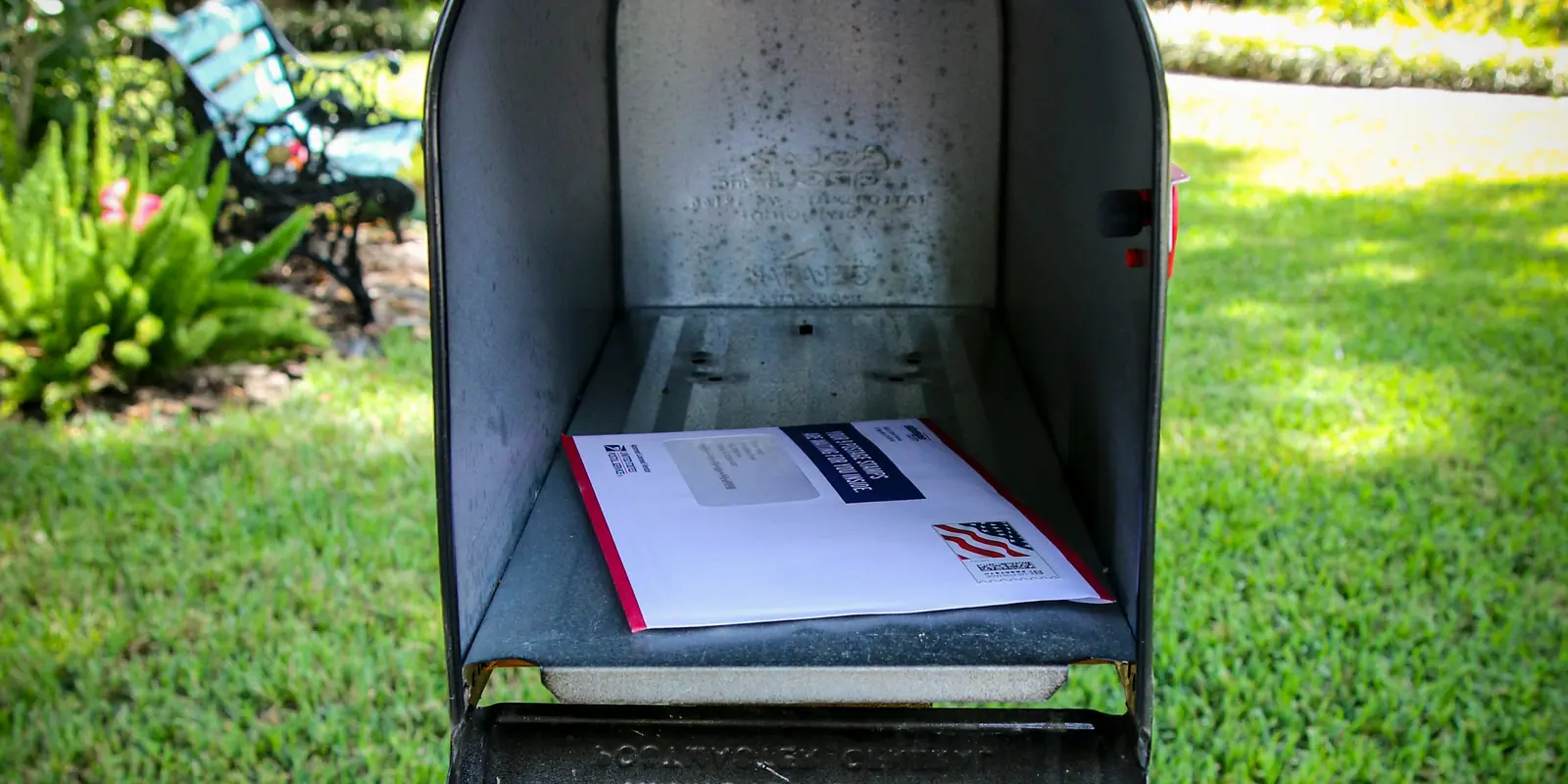 An open mailbox with a letter waiting inside